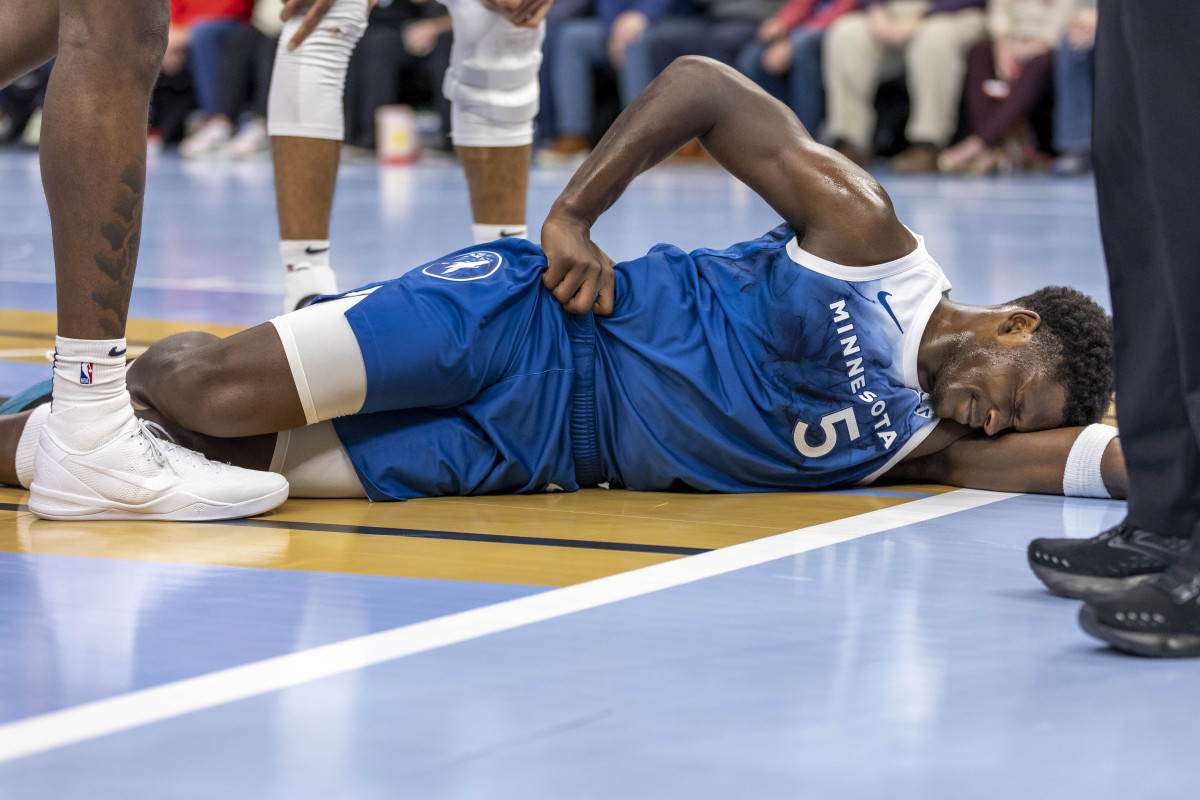 Nov 28, 2023; Minneapolis, Minnesota, USA; Minnesota Timberwolves guard Anthony Edwards (5) reacts after landing on the floor against the Oklahoma City Thunder in the second half at Target Center.